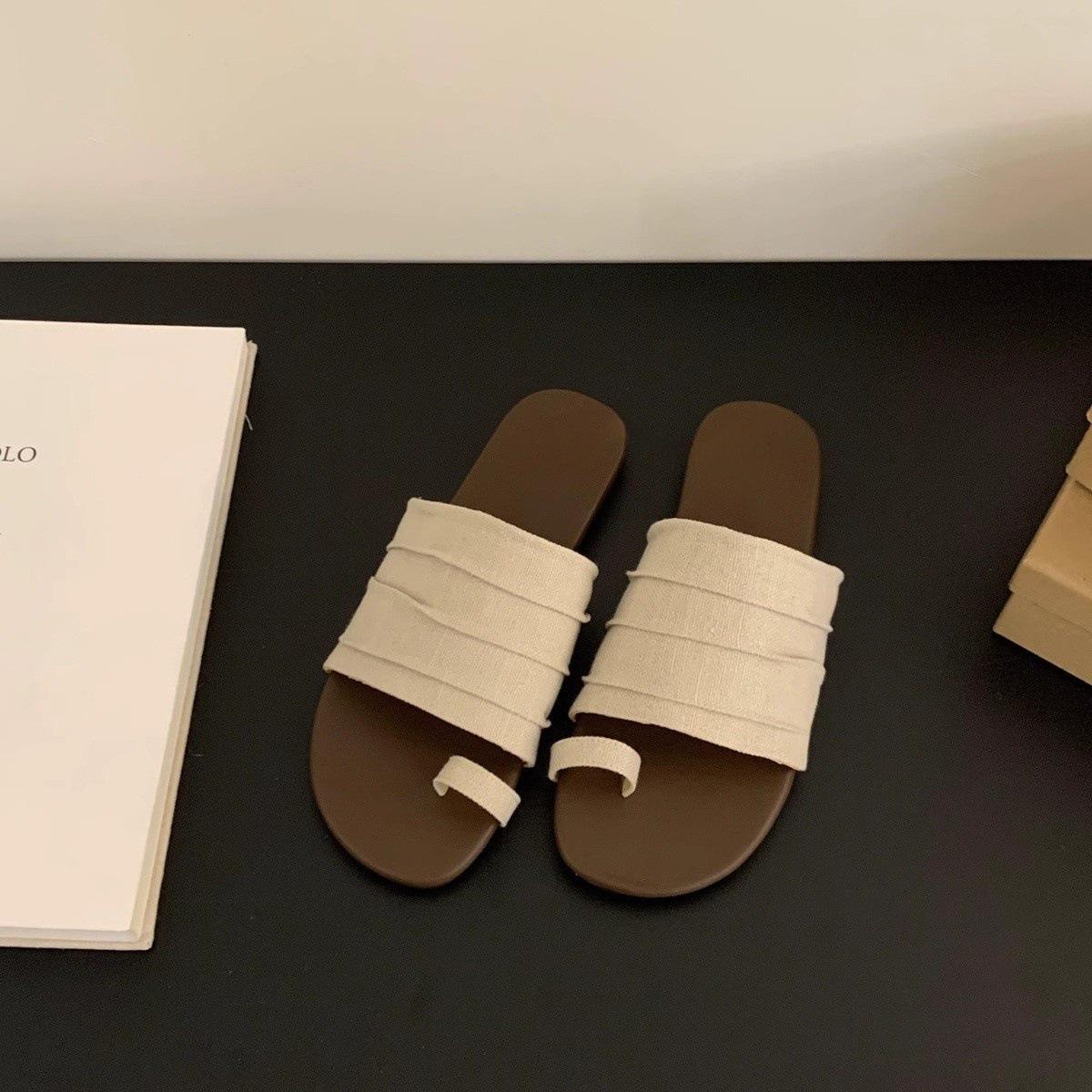 

Holiday wind cover toe flat slippers women s outer wear summer 2025 new casual one-word drag temperament beach women s shoes 35