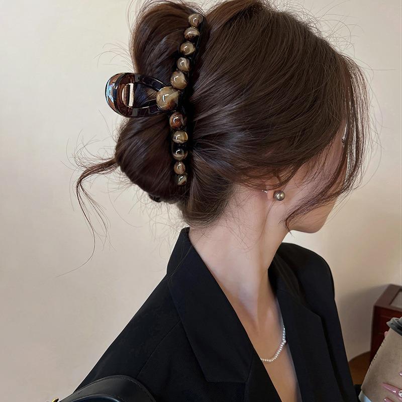 A Gradient Round Bead Shark Clip A Large Hair Clip and A Hairpin for The Back of A Woman's Head