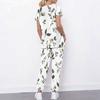 Women Plus Size White Floral Printed Scrub Set Crisscross Cutout Neck Short Sleeve Top With Pockets Long Pants Two Piece