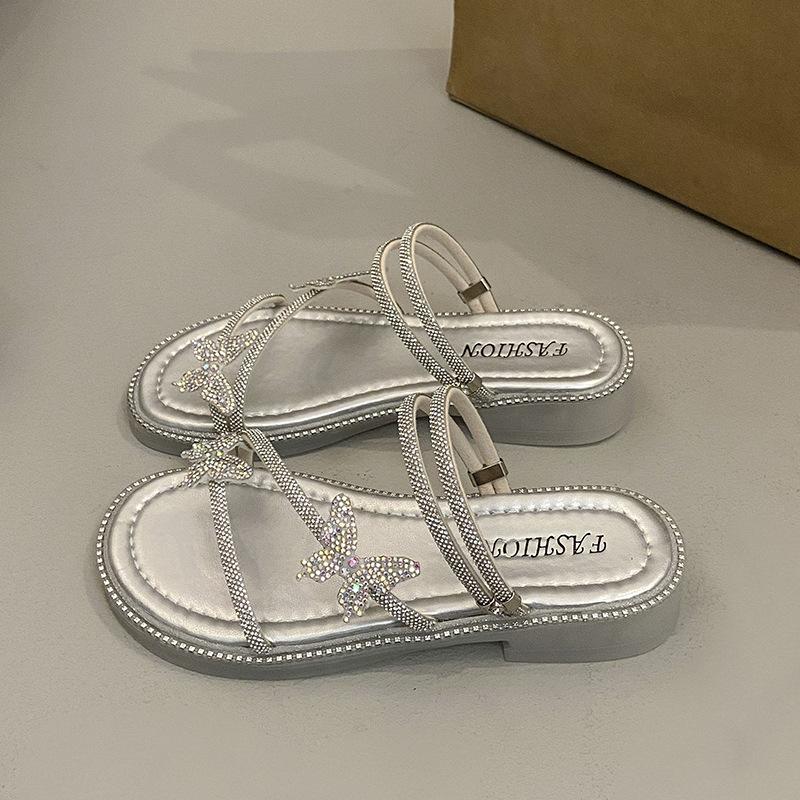 Beautiful slippers female 2025 summer wear new Internet celebrity butterfly rhinestone one-word drag fairy wind beach two sandals