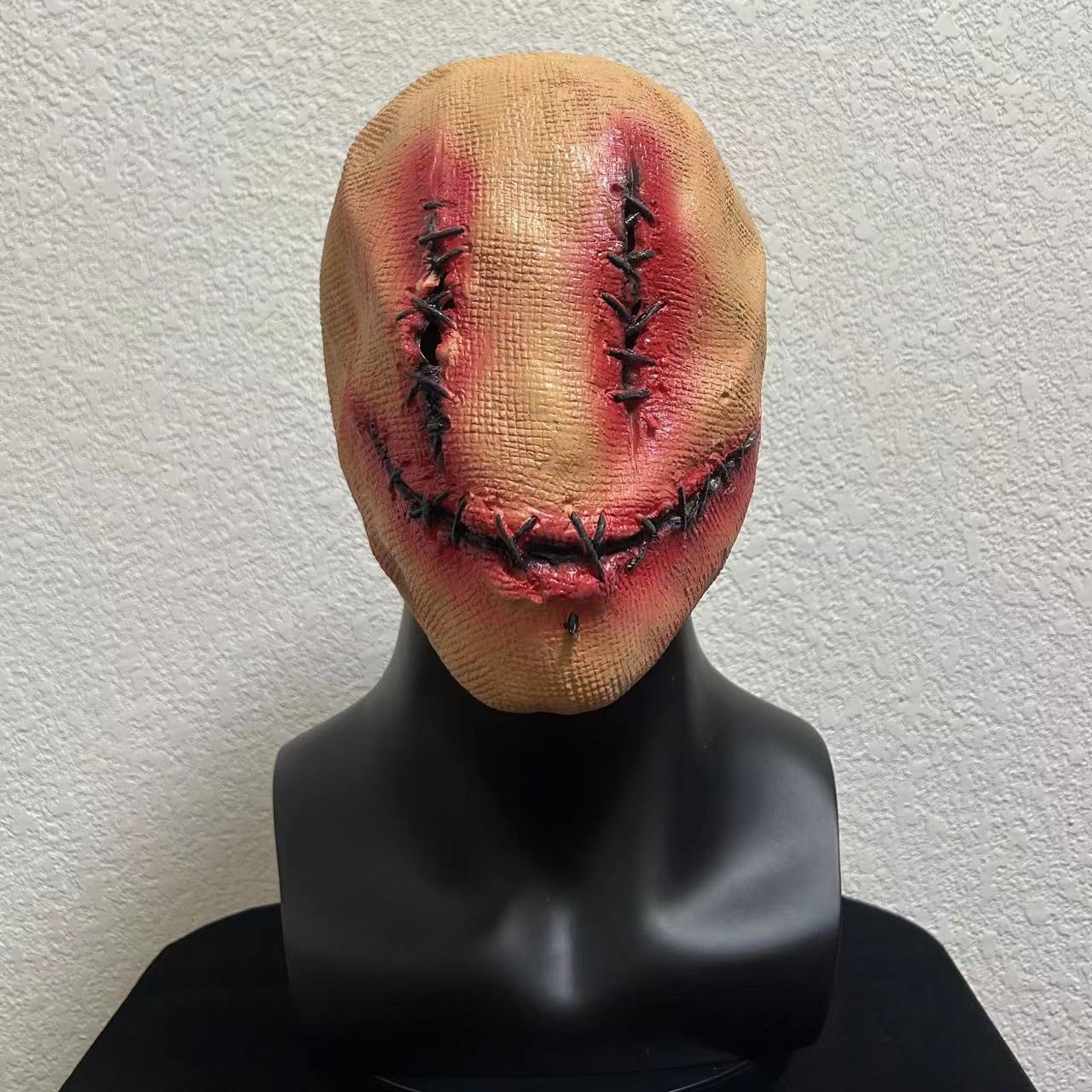 

A terrifying half-faced female ghost headgear with a sack, a scary decoration and atmosphere prop in a haunted room