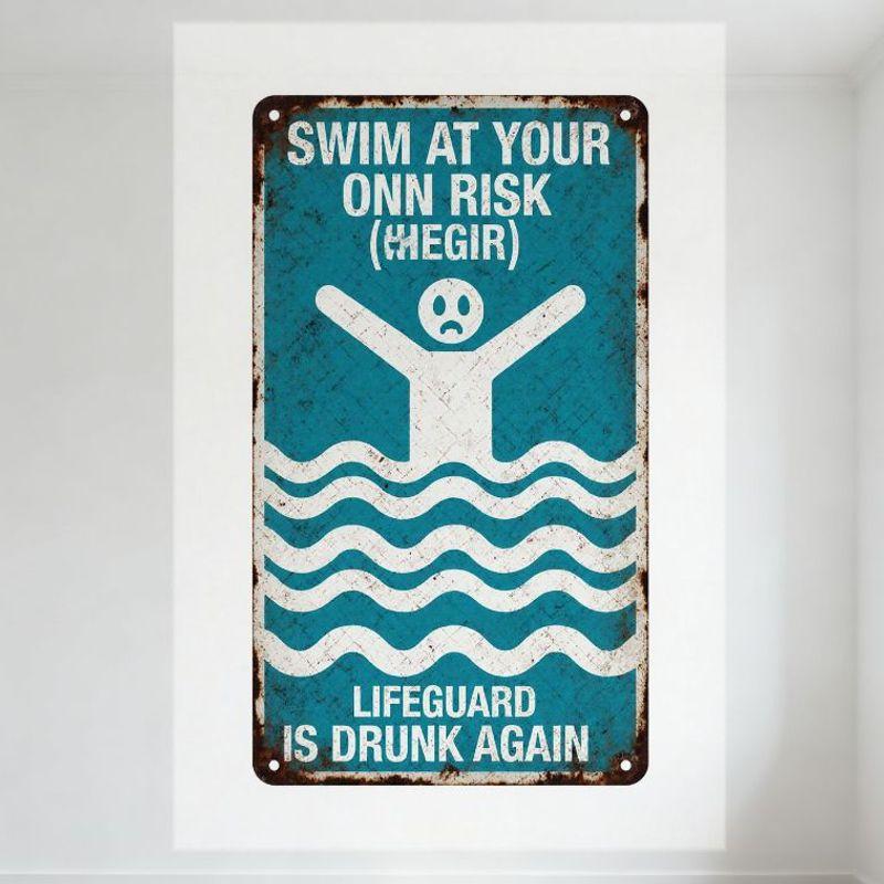 

Vintage Metal Tin Sign Blue Background Swim At Your Own Risk (Hegir) Lifeguard Drunk Graphic for Man Cave Home Decor 20x30cm（7.8x11.8inch）