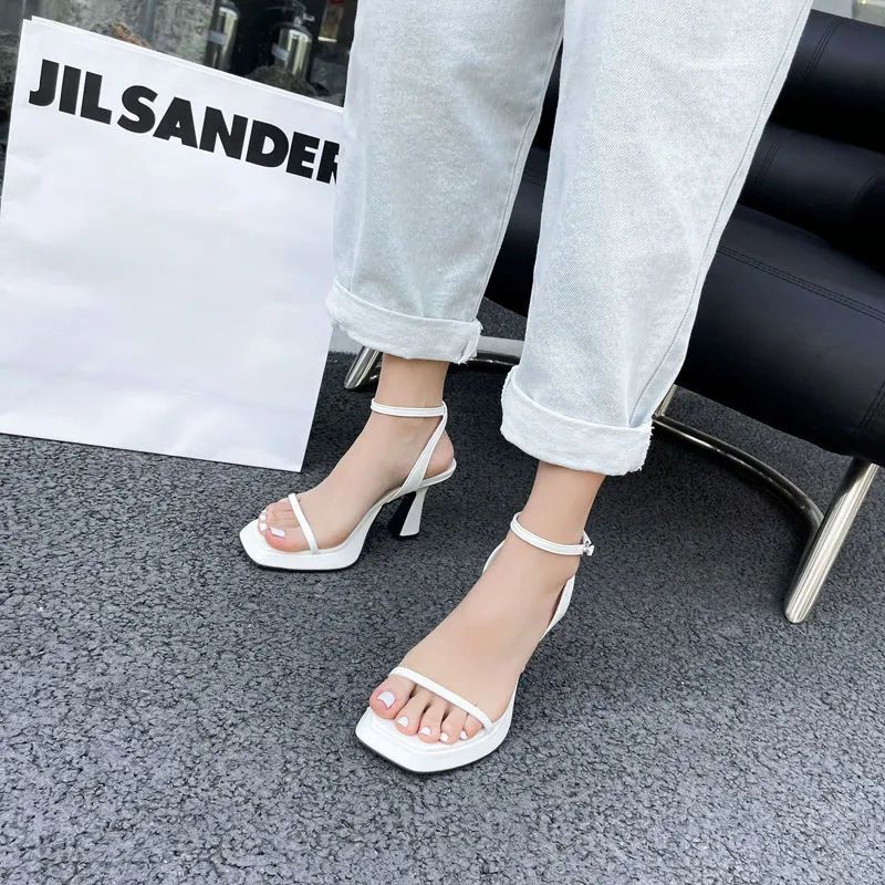 Spring and summer one-word buckle high heels design sense niche pink sexy waterproof table square head sandals women