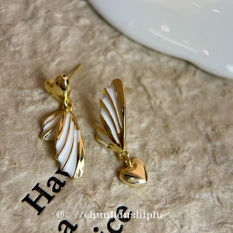 

Asymmetrical love, oil dripping, mosquito coil disc, ear clips, high-end niche earrings, women s unique design, no pierced ears