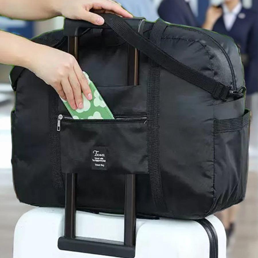 Compact travel bag: suitcase-compatible, hand-held, features an external pocket, handle slip-over design, with matching accessory bag.
