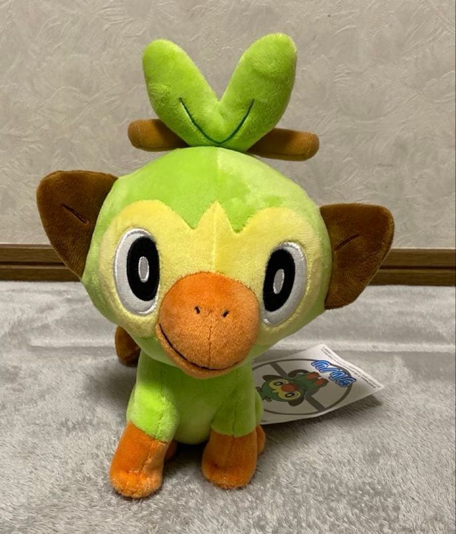 Exclusive plush toy Grookey from Pokemon Center brand tags.