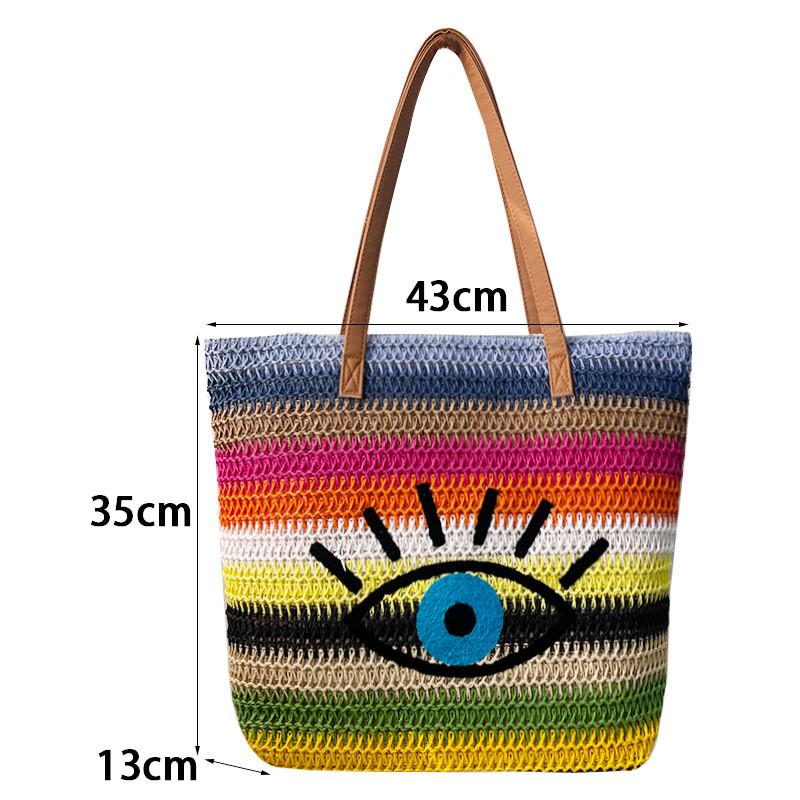 Große geflochtene Raffia-Strandtasche mit Augen-Print-Design und zwei Schultergurten für den Urlaub