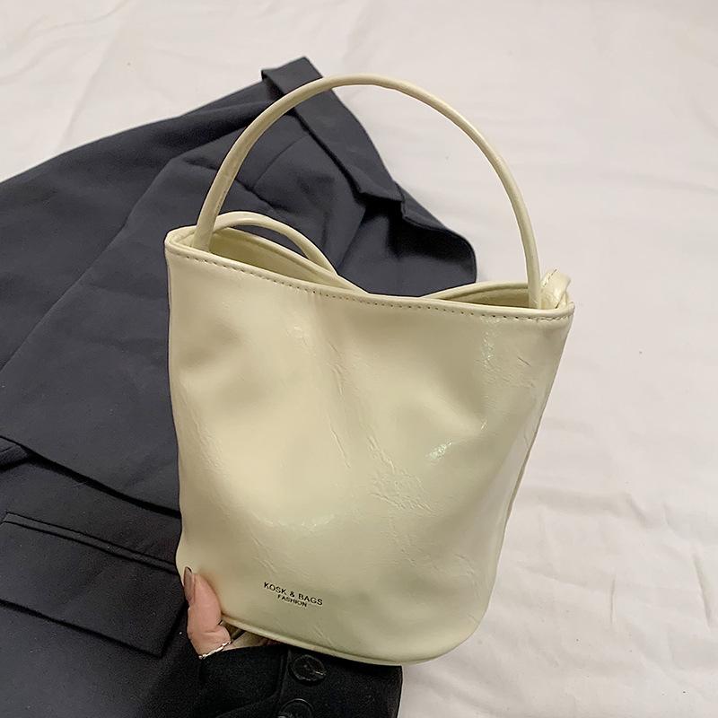 

Новый продукт оптом ощущение высокого класса простой однотонный кремовый ветер портативная сумка-ведро в иностранном стиле универсальная сумка-мессенджер для通勤 сумка женская