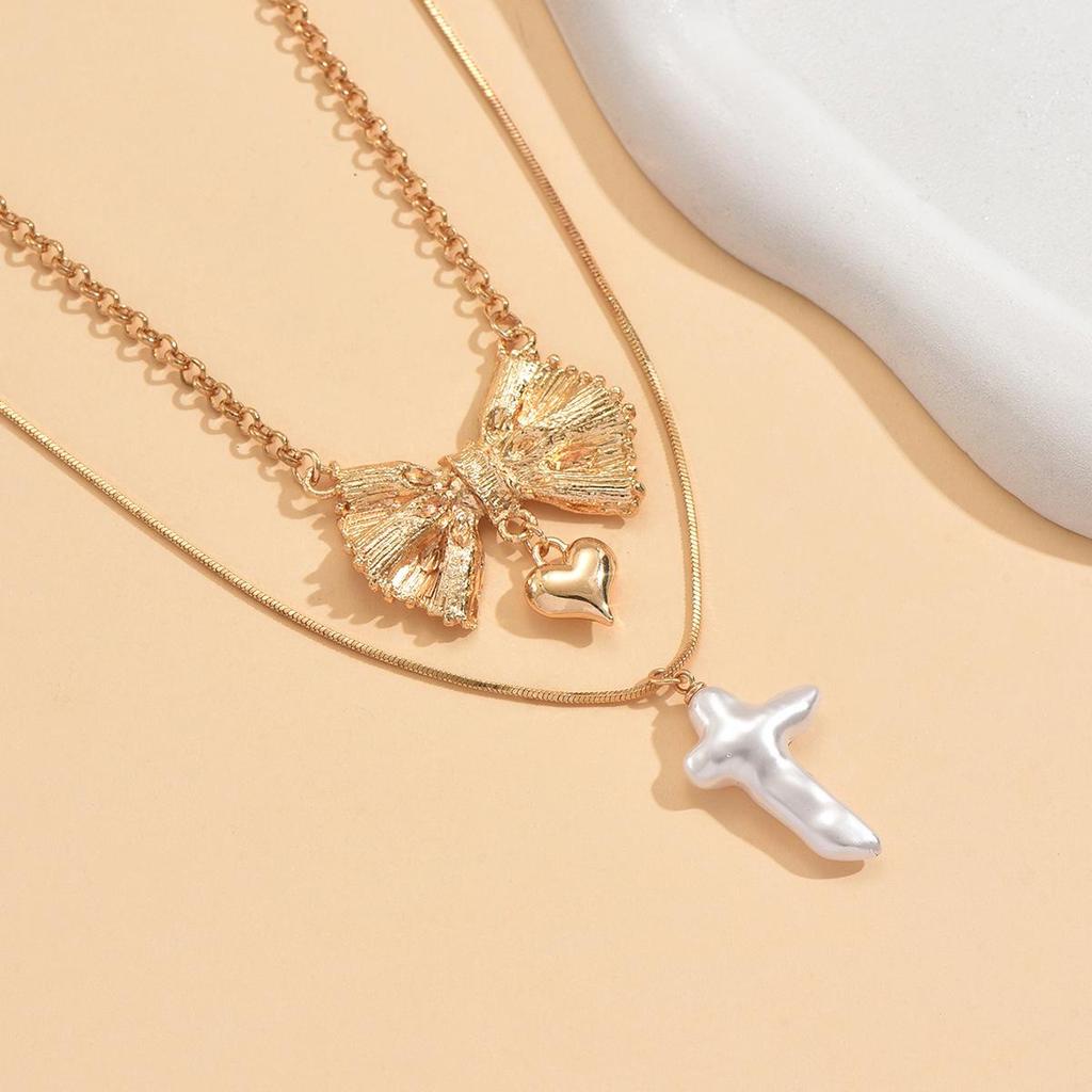 Europäische und amerikanische Doppelreihen-Schleife Herz Kunstperlen-Anhänger Halskette für Damen - High-End Nischendesign