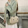 Neutral men's and women's cross-body bag with shoulder strap, made of corduroy material, with a flap design  the outside.