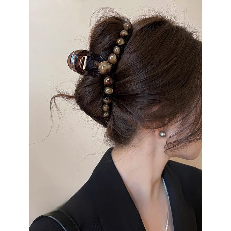A Gradient Round Bead Shark Clip A Large Hair Clip and A Hairpin for The Back of A Woman's Head