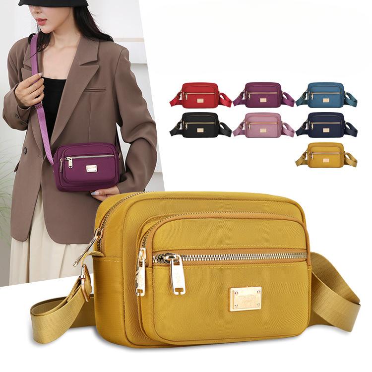 New Portable Oxford Cloth Mother Bag Fashion Simple Multi Layer Middle Aged Shoulder Bag Atmosphere Joker Slung Small Bag.