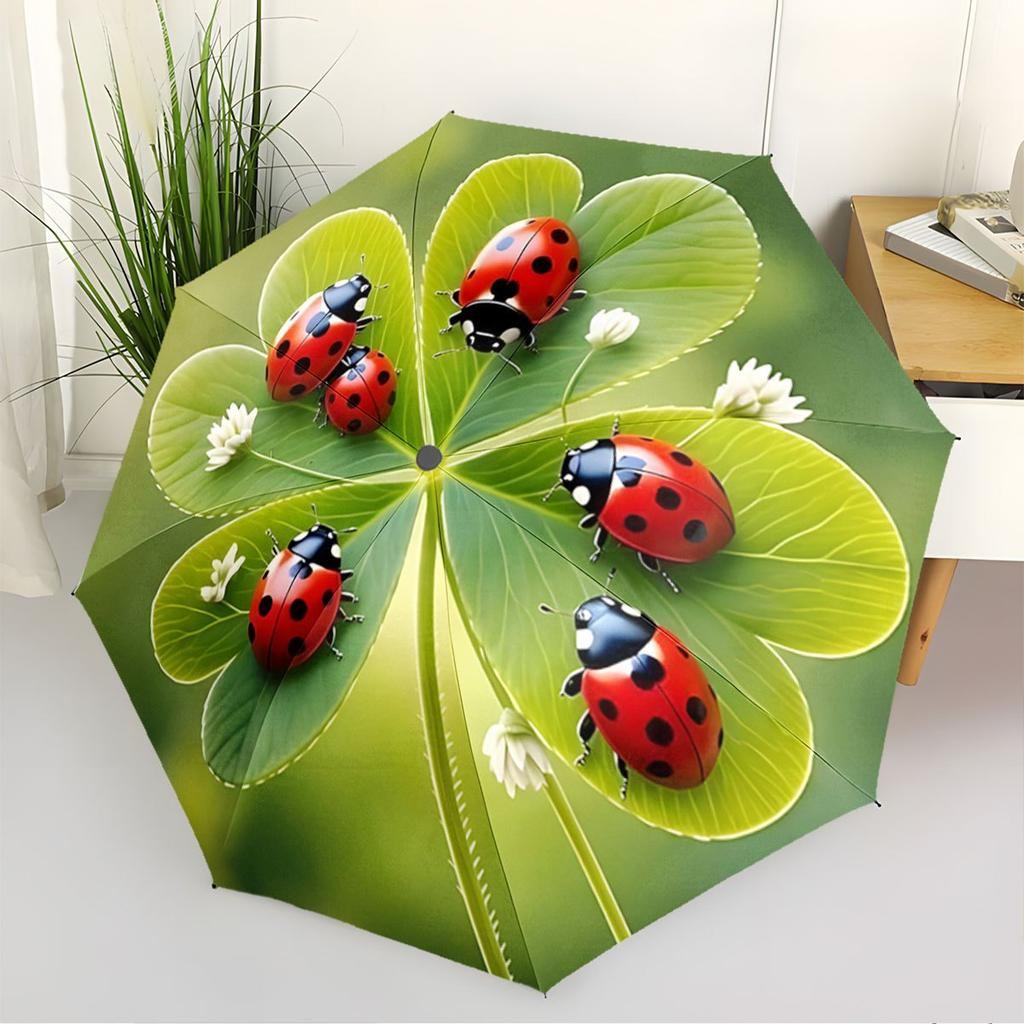 A Compact Folding Umbrella Featuring Ladybugs On a Backdrop of Green Leaves, Perfect for Gifting On Any Occasion.