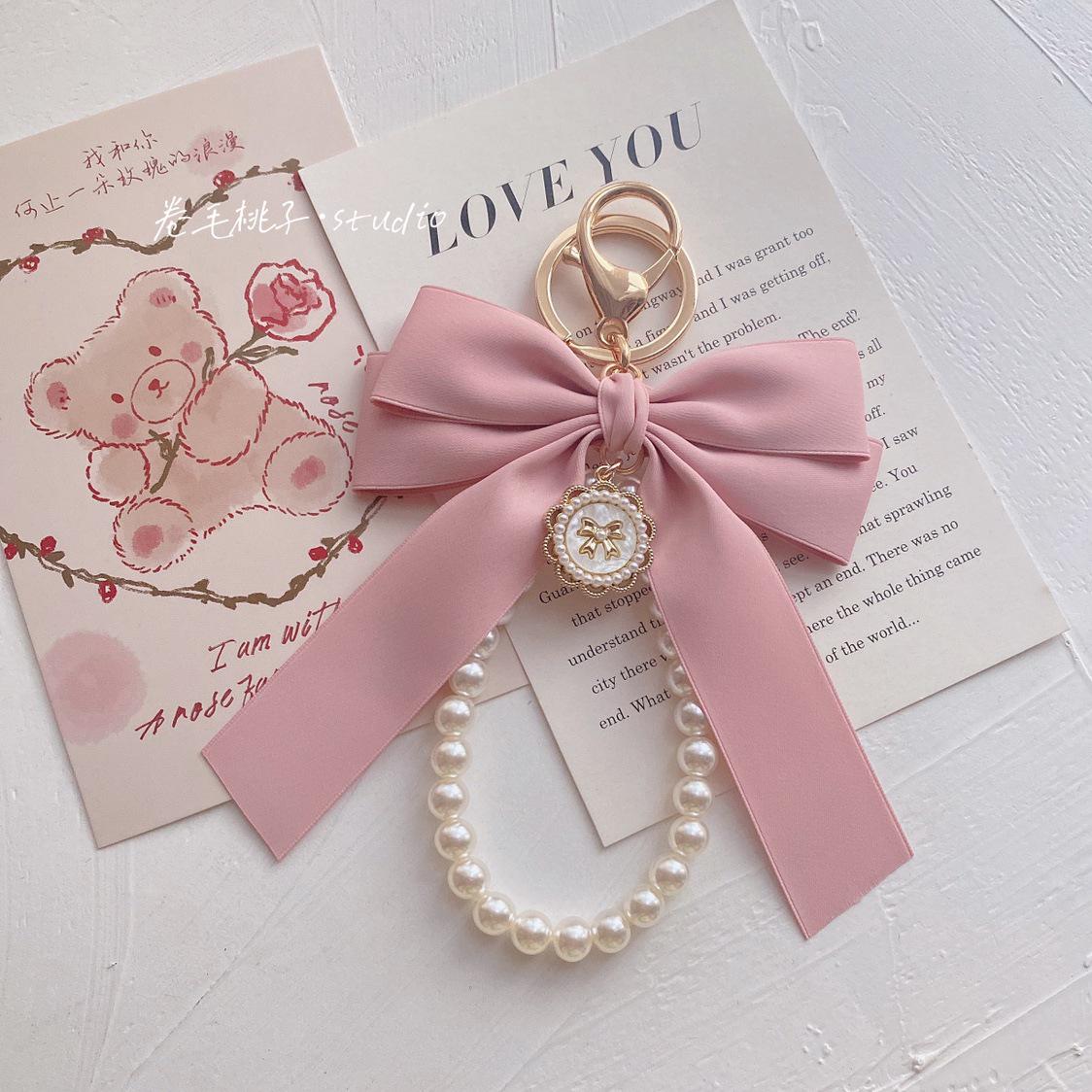 

Owner s Pearl Keychain: Matte Powder Bow Pendant for Girls