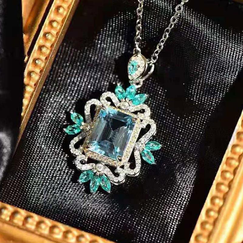 Vintage Style Blue Gemstone Pendant Necklace with Floral Accents Elegant Ornate Statement Necklace for Women