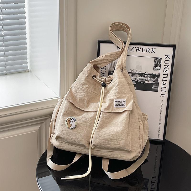 

New backpack Korean version of women s niche drawstring backpack large capacity nylon light commuter portable shoulder bag хакі