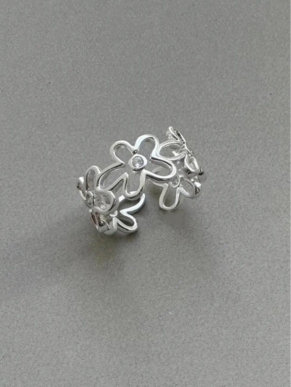 

Регулируемое широкое кольцо с цветочным ажурным узором и бриллиантовыми акцентами