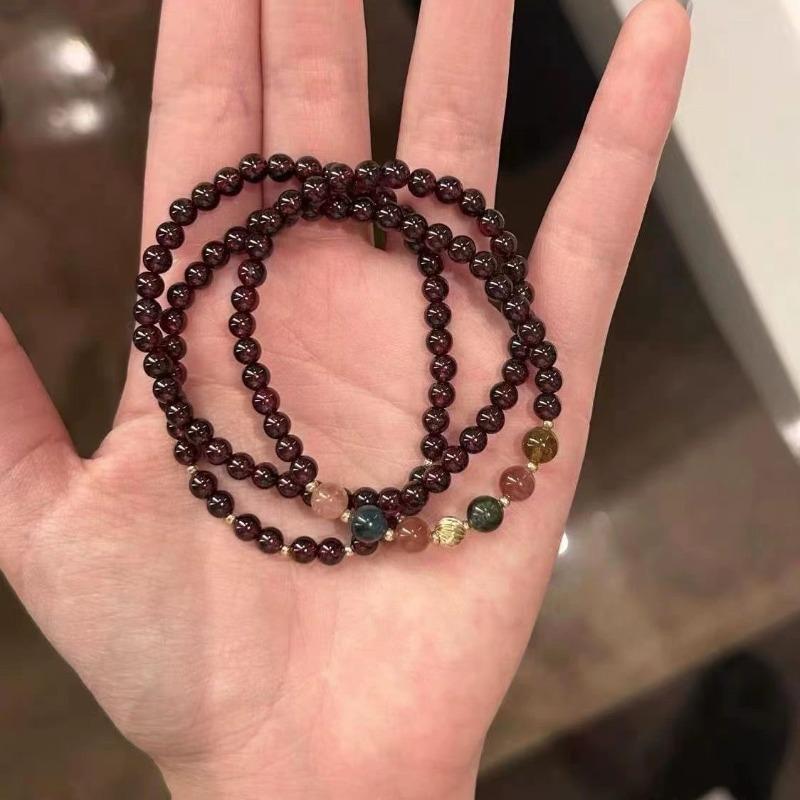 

Wear Multiple Layers of Red Pomegranate Bead Bracelets and Two Necklaces. This Is A Simple, Retro and High-end Accessory.