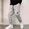 Pantalones deportivos casuales de color liso para hombre con bolsillos y cordón ajustable para uso deportivo y casual.