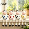 Cow Figurine Resin Statue, Cute Shelf Sitter with Dangling Rope Legs, Garden Decor for Patio Cartoon Farmhouse Animal Ornament Fence Railing, Planter,