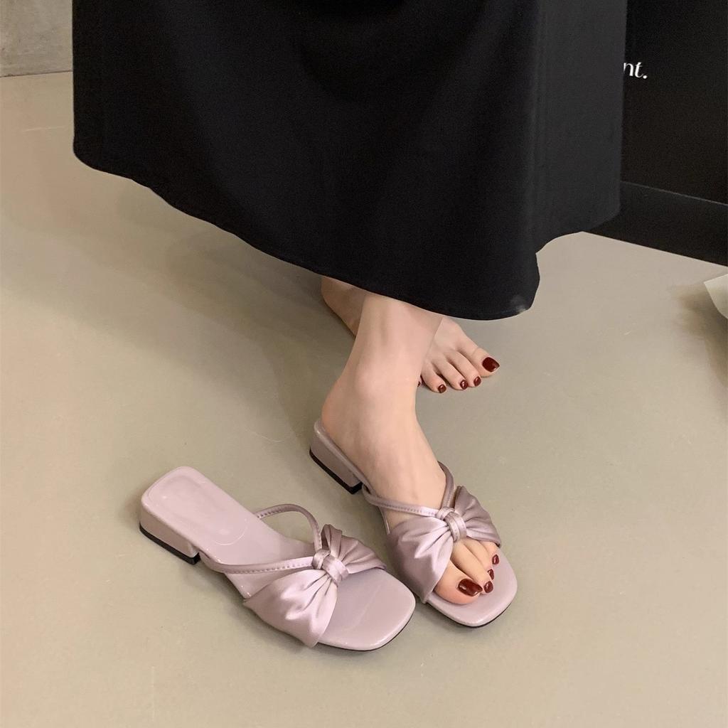 French beautiful slippers women's summer wear 2025 new fairy bow one-word drag thick heel with skirt beach sandals