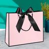 In-Stock White Cardboard Gift Bags with Bow Handle, Customizable Logo for Clothing Stores