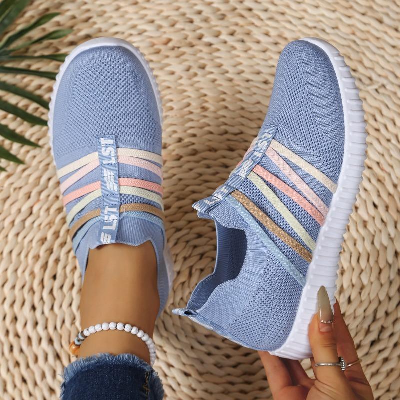 The Lady Wears Slip-On Casual Sports Shoes, Featuring a Breathable Mesh Design with Pastel Stripes, Suitable for Tennis And Comfortable