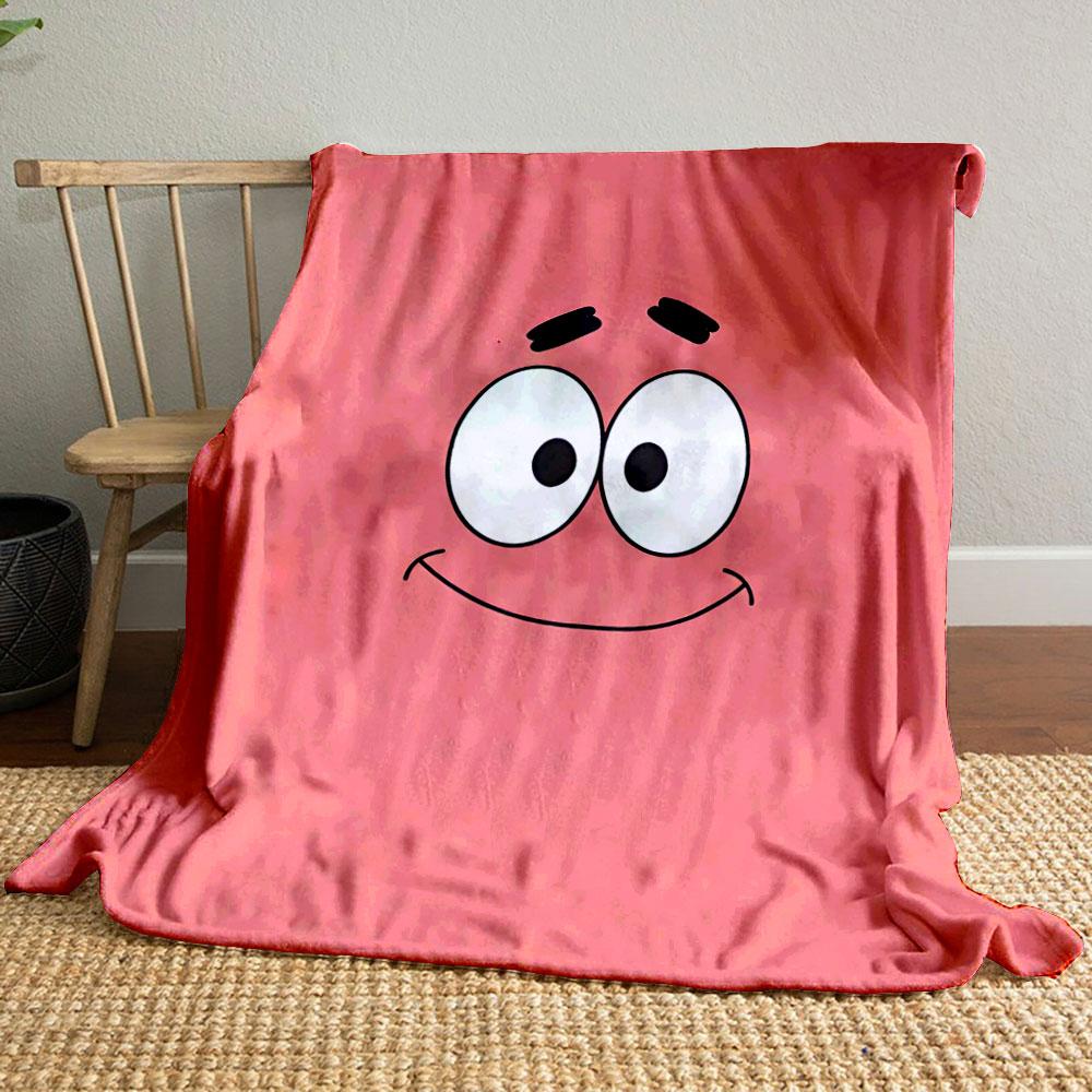 A simple pink background with a smiling cartoon face and wide eyes. for all seasons blanket lunch break throw gift