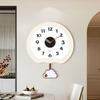 This wall clock is a modern, creative and personalized quartz clock for home use in the living room with a simple cream style