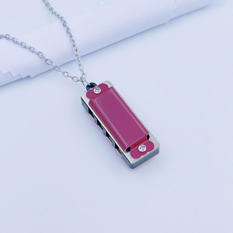 

Swan Cross 4-Hole Harmonica Necklace: Mini Wind Instrument for Children & Beginners