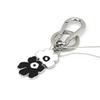 Marimekko Puhallus Unikko I Kioski Key Chain (Black and White) 093606 910. This black and white metal floral logo keychain features a Nordic