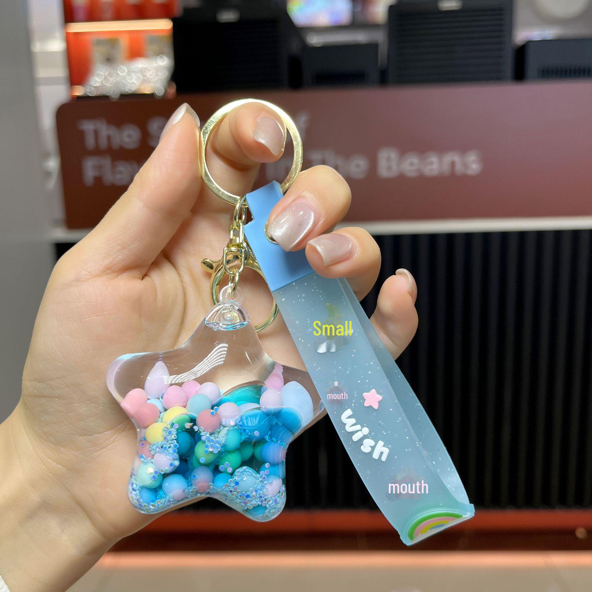 

Подвеска-брелок в виде звезды из акриловых желейных бобов с масляным наполнением в виде зыбучего песка звезда/синий