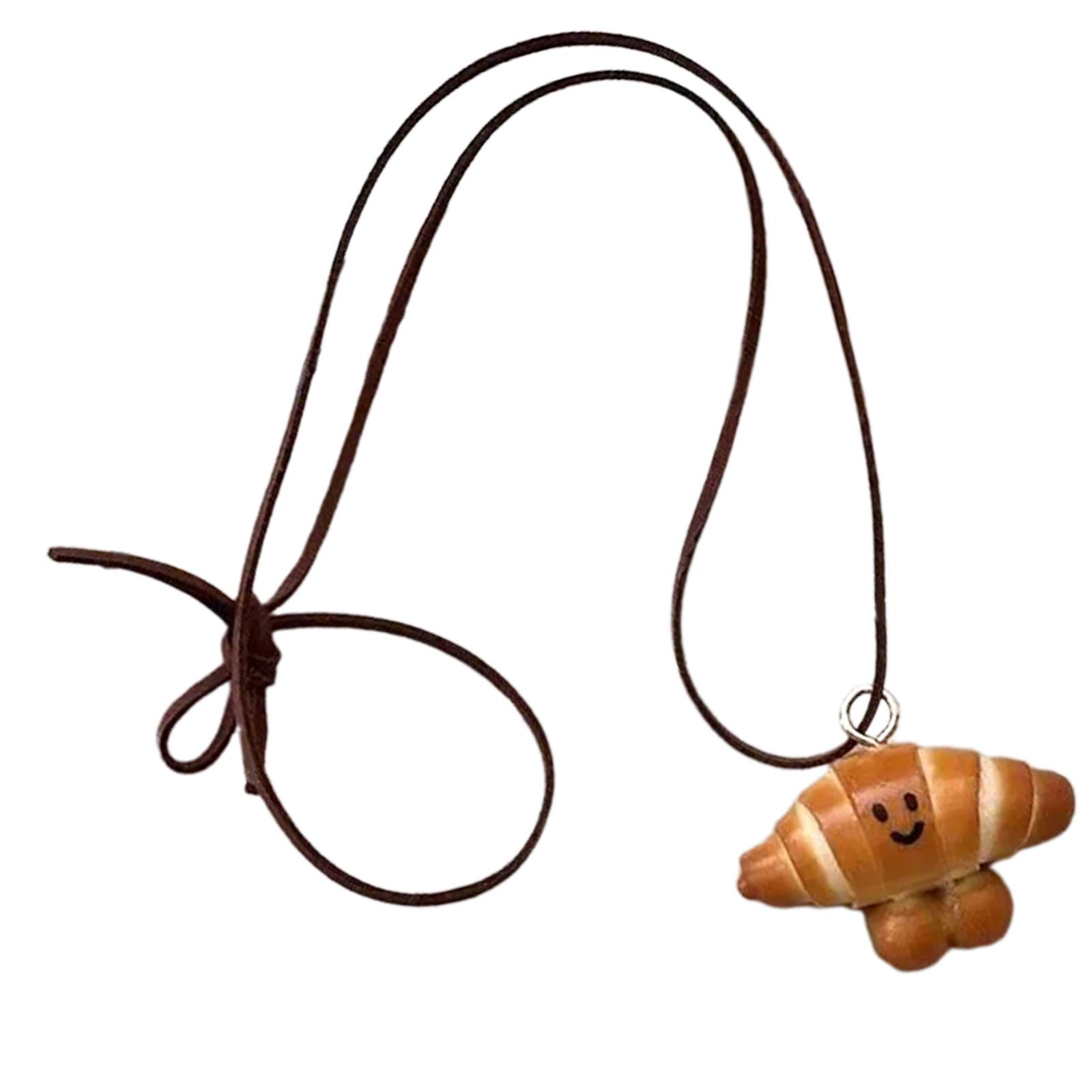 

Многофункциональное художественное ожерелье с подвеской в виде хлеба, украшенное миниатюрами в виде венка и улыбающегося кренделя, модный аксессуар B