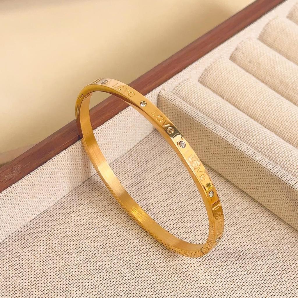 Luxusní dámský náramek z titanové oceli se zirkony a akcenty z bílé perleti