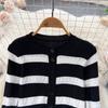 Autumn And Winter Korean Version Of The Collision Color Stripes Hollow Knitted Cardigan Plus Half-Body Skirt Two-Piece Set