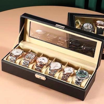 Boîte d'exposition en cuir pour montres et bijoux avec plusieurs compartiments et lucarne