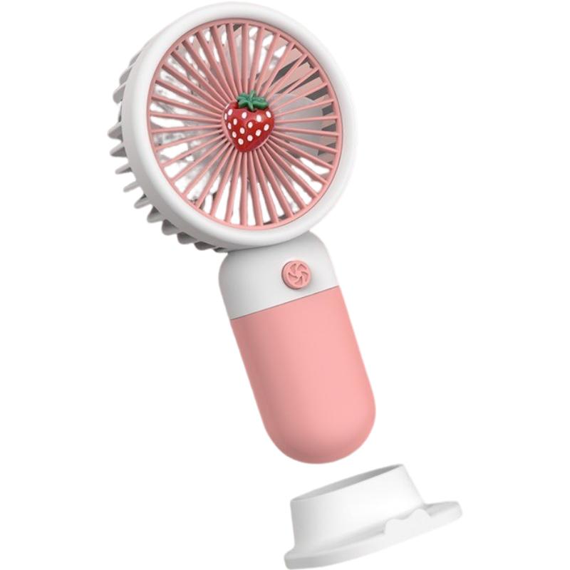 

Держатель для мобильного телефона Ручной вентилятор Открытый портативный мощный ветер Мини Креативный настольный фруктовый электрический вентилятор розовый