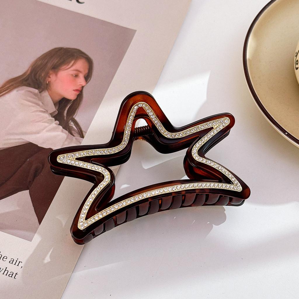 Elegant stjärnformad hårklämma för kvinnor med fantastiska strass i svarta och bruna toner