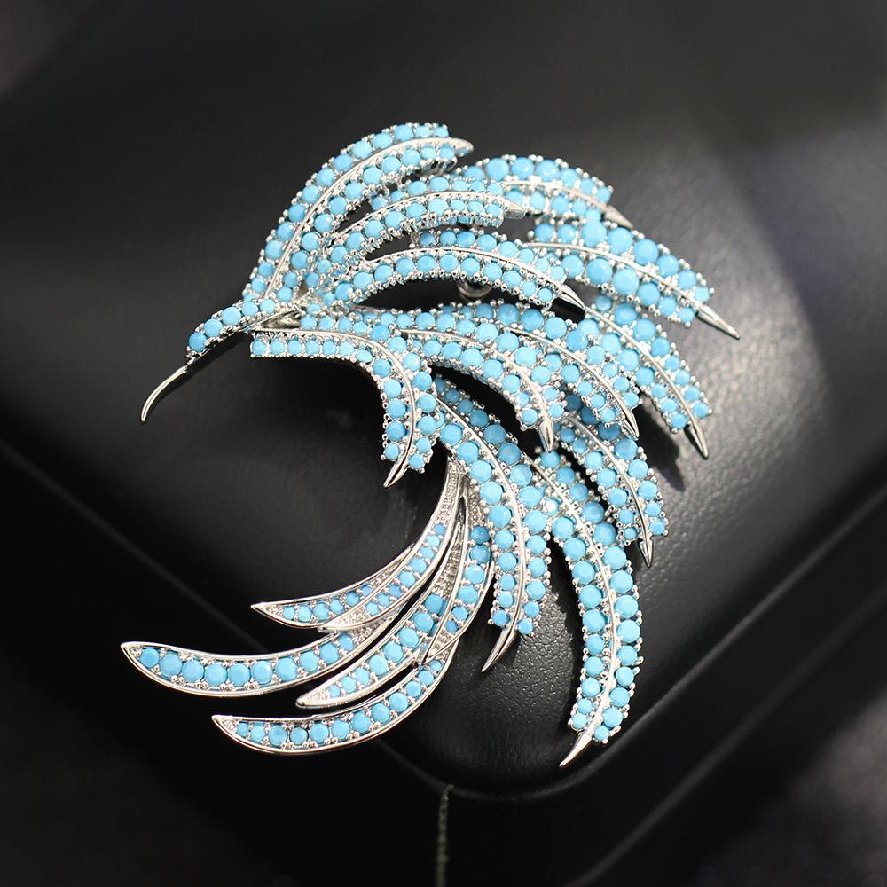 

New high-end blue zircon inlaid stone phoenix feather brooch niche light luxury anti-light pin accessories women s models