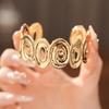 Spiral Lumina Oval Hollow Metal Statement Bracelet-Hand Ring with High-End Niche Appeal