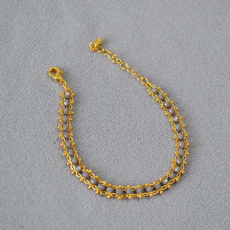 

Граненый браслет из черной шпинели с золотым покрытием серый