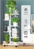 Multi-tier Wrought Iron Plant Stand: Movable Flower Pot Holder for Balcony or Living Room.
