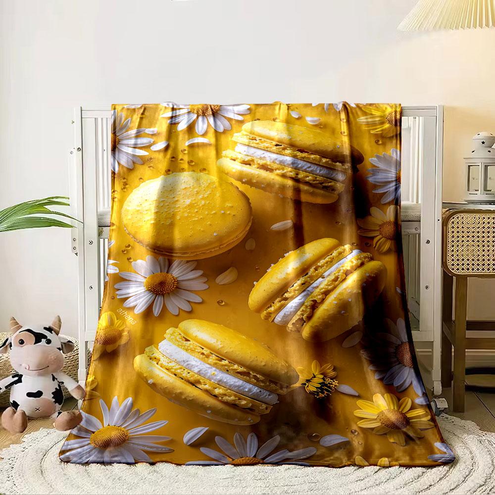 Yellow macarons surrounded by daisies on a matching yellow background. for all seasons blanket lunch break throw gift 80cm x 120cm