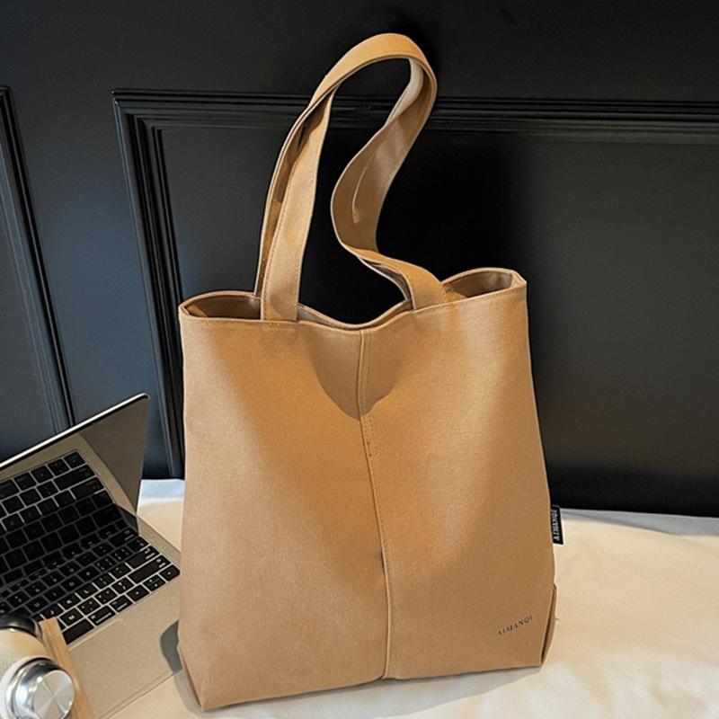 Eine modische und schlichte Umhängetasche aus Stoff mit großem Fassungsvermögen für Pendler-Studenten