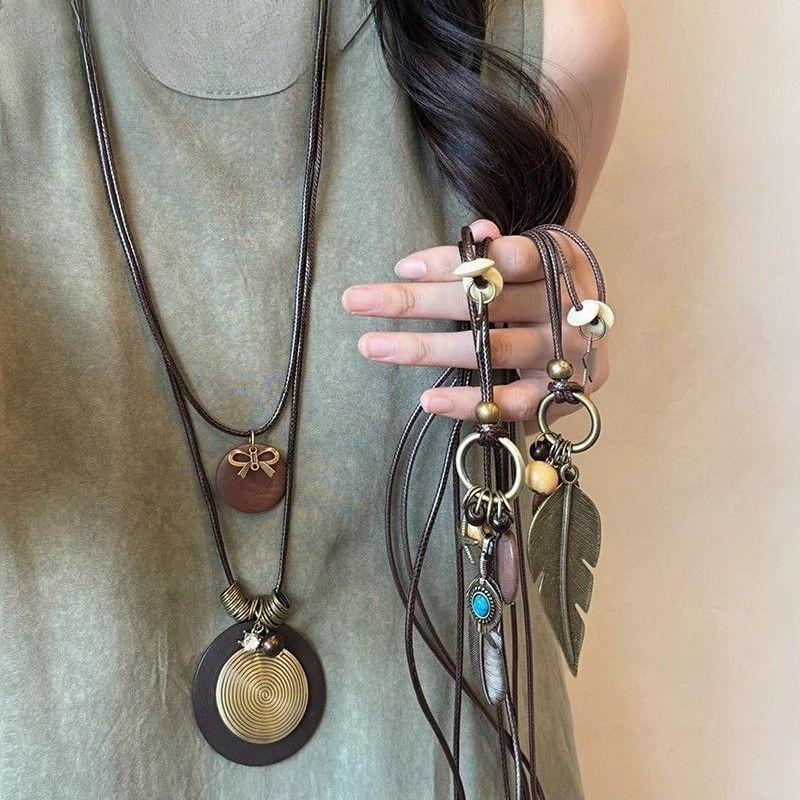 Zen-inspired Long Feather Necklace for Women, Featuring A Retro Ethnic Style and Multiple Layers of Sweater Chains, New Design.