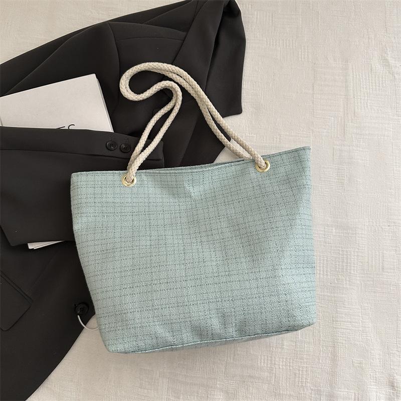 Plaid woven tote bag women's 2025 new high-value commuter art students class handheld cloth bag tide