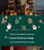 Santa Claus lezoucí po žebříku Dekorace na vánoční stromek a okno Světla