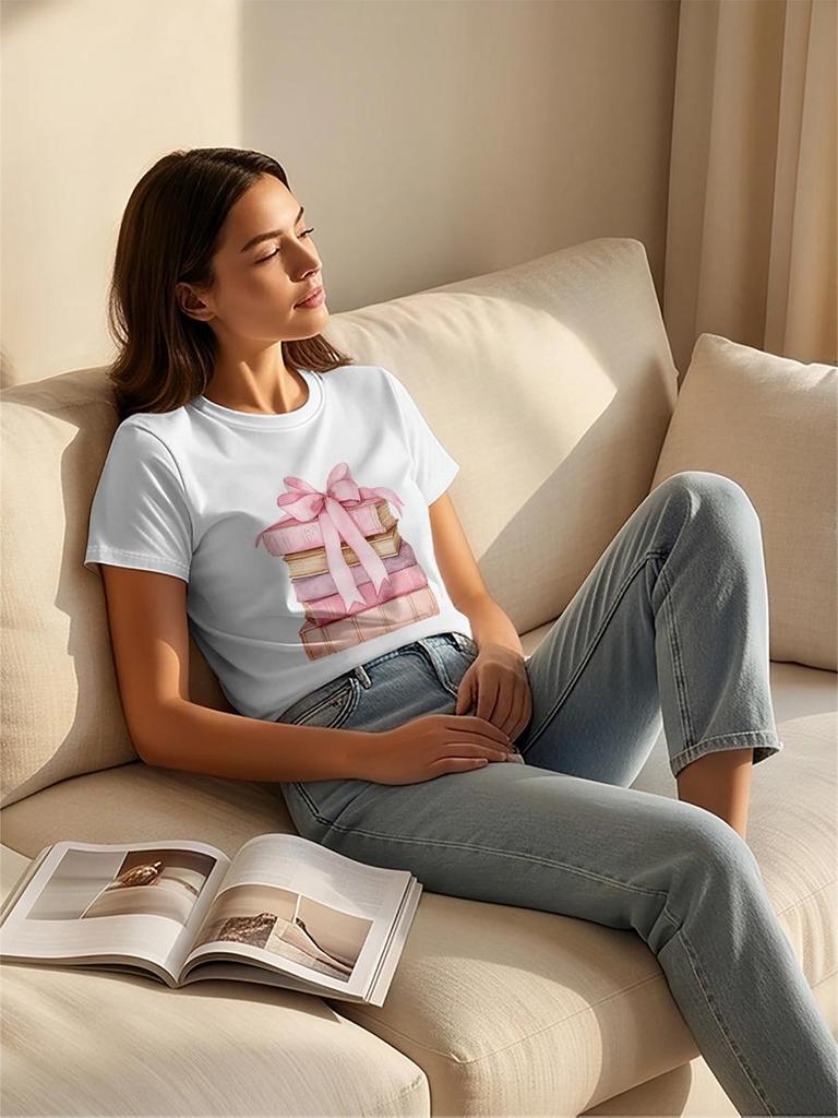 A stylish and versatile white T-shirt with pink book and bow-themed details, perfect for a sophisticated summer look.