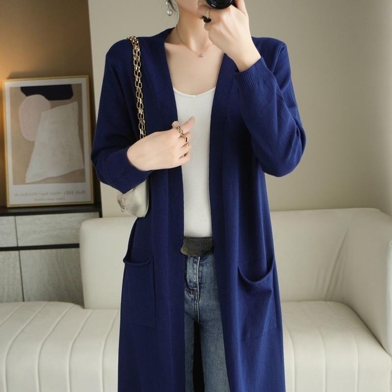Un nouveau manteau-pull mi-long pour l'automne et l'hiver. Portez un pull à manches longues de couleur unie sur un gilet en tricot longueur genou pour femme
