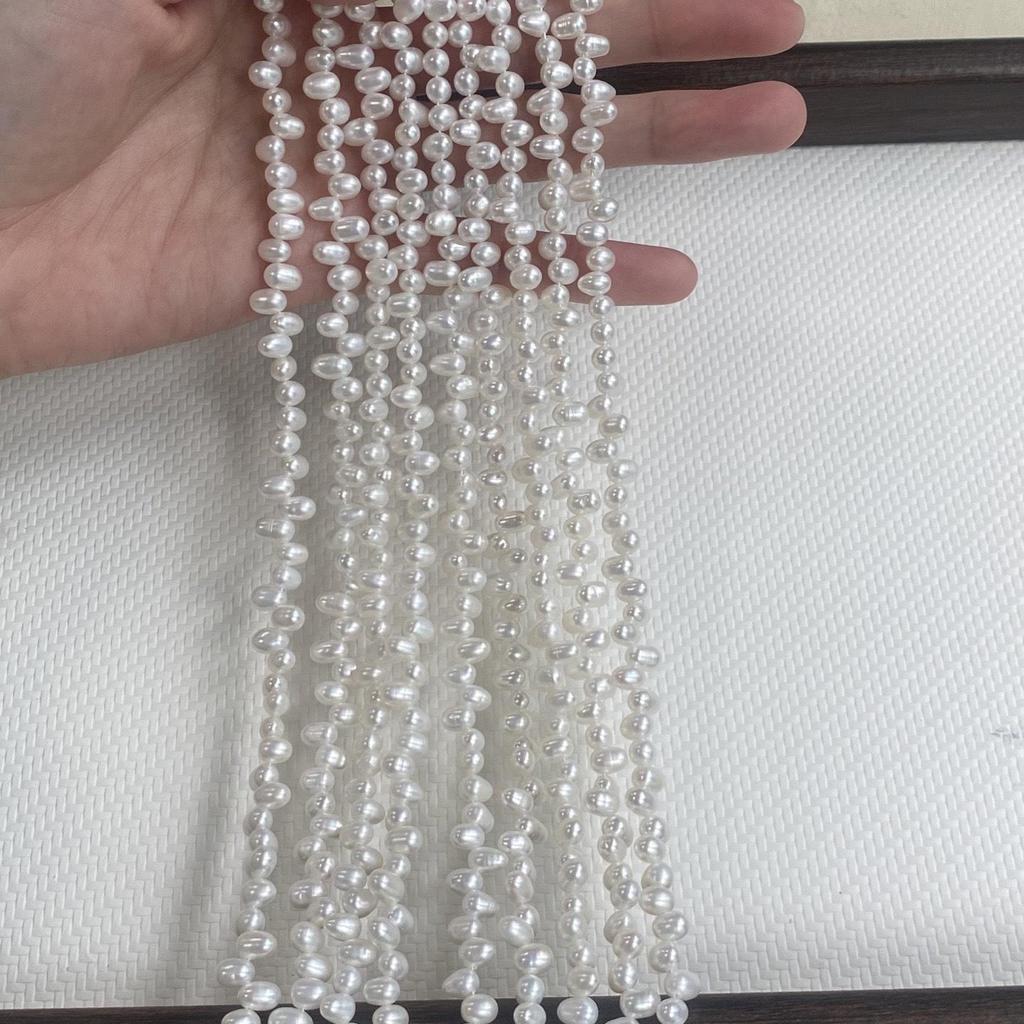 Natural Freshwater Rice-Shaped 4-5mm Necklace Beads with Tiny Flaws and Two-Eight Hole Design for DIY Jewelry.